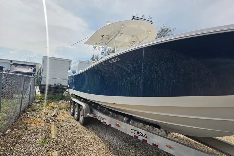 Slide: The Image of 2018 Regulator 34 Center Console boat on trailer, parked outdoors. - 58