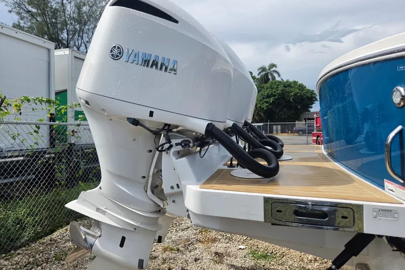 Slide: The Image of 2018 Regulator 34 Center Console with Yamaha outboard engines, docked outdoors. - 57