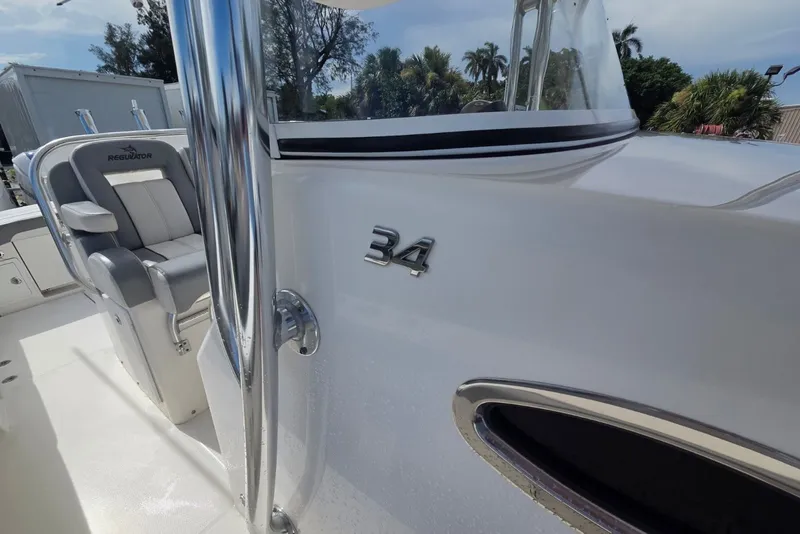Slide: The Image of 2018 Regulator 34 Center Console boat interior with seating and chrome details. - 15