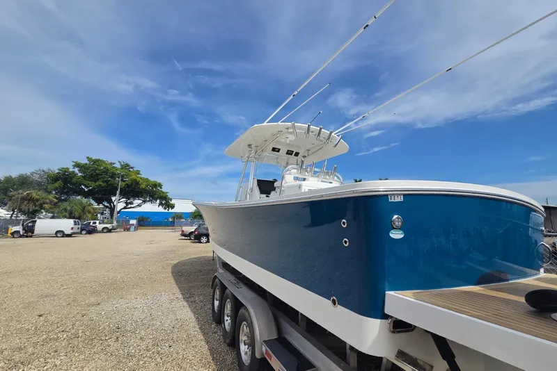 Slide: The Image of 2018 Regulator 34 Center Console boat on trailer under blue sky. - 44