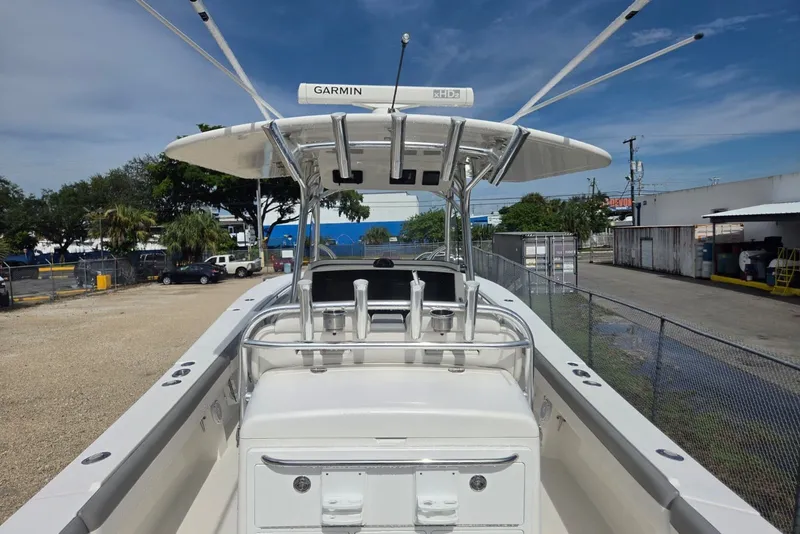 Slide: The Image of 2018 Regulator 34 Center Console boat with Garmin equipment, docked outdoors under clear skies. - 35