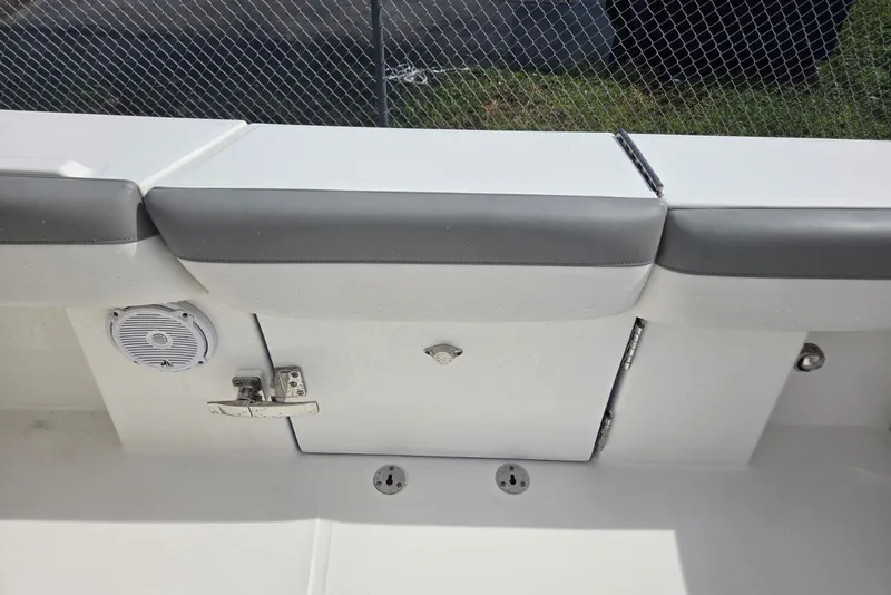 Slide: The Image of 2018 Regulator 34 Center Console boat interior with cushioned seating and speaker. - 31