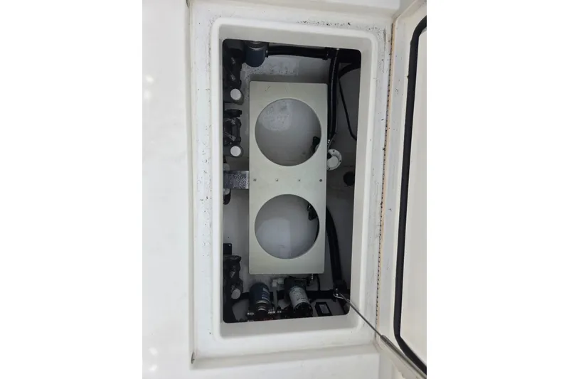 Slide: The Image of 2018 Regulator 34 Center Console storage compartment with mechanical components visible. - 30