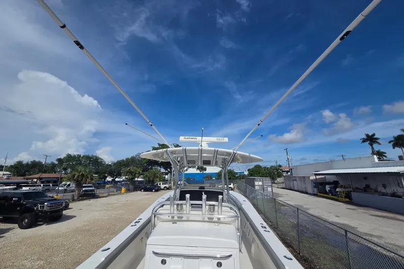 Slide: The Image of 2018 Regulator 34 Center Console boat with Garmin equipment under a clear blue sky. - 18