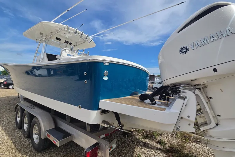 Slide: The Image of 2018 Regulator 34 Center Console boat on trailer with Yamaha outboard motor. - 45