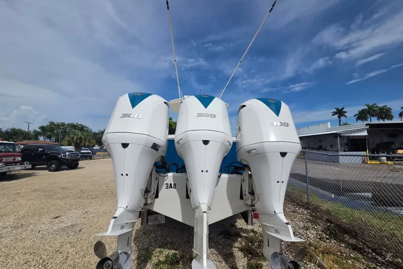 Slide: The Image of 2018 Regulator 34 Center Console with triple 300 horsepower engines, parked outdoors. - 49