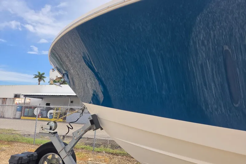 Slide: The Image of 2018 Regulator 34 Center Console boat on trailer, blue hull, outdoor setting. - 61
