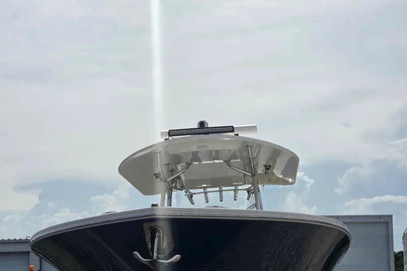 Slide: The Image of 2018 Regulator 34 Center Console boat with T-top against cloudy sky. - 39
