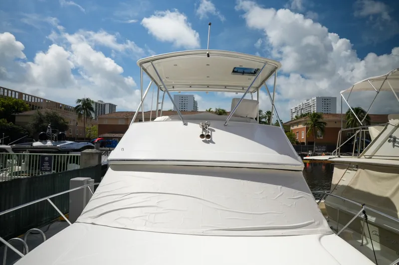 Slide: The Image of 2014 Silverton 36 Convertible yacht docked under a partly cloudy sky. - 9