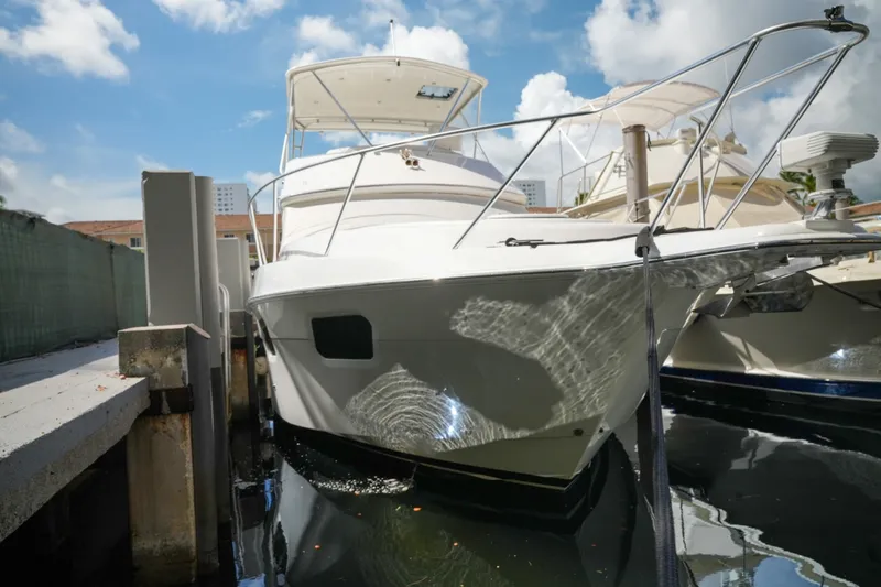 Slide: The Image of 2014 Silverton 36 Convertible yacht docked under a clear blue sky. - 7