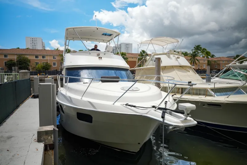 Slide: The Image of 2014 Silverton 36 Convertible yacht docked at marina under cloudy sky. - 29