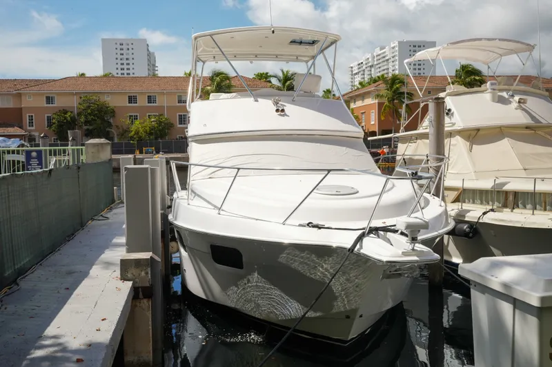 Slide: The Image of 2014 Silverton 36 Convertible yacht docked in a marina under a partly cloudy sky. - 5