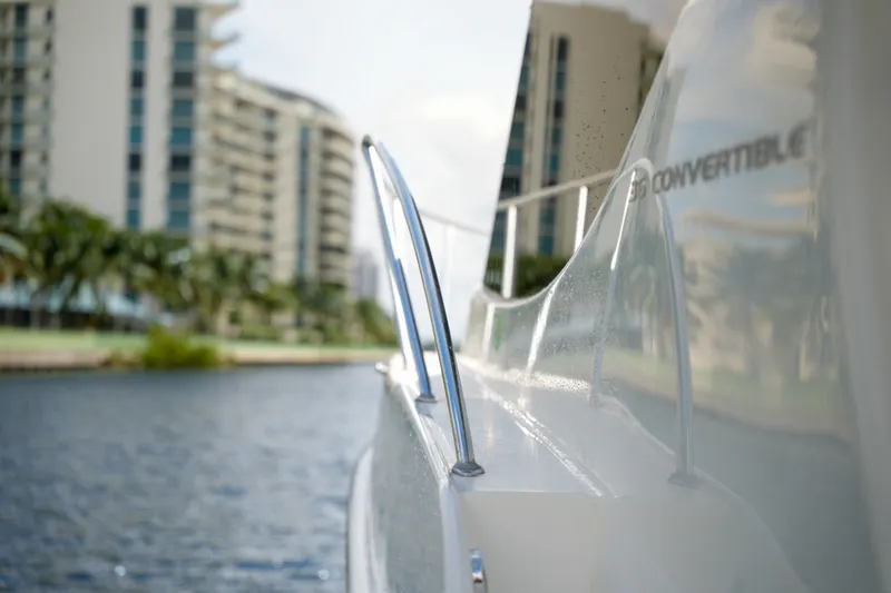 Slide: The Image of 2014 Silverton 36 Convertible yacht near waterfront buildings. - 15