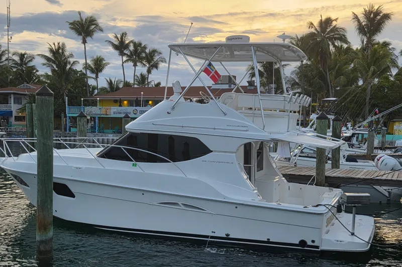 Slide: The Image of 2014 Silverton 36 Convertible yacht docked at marina during sunset. - 1