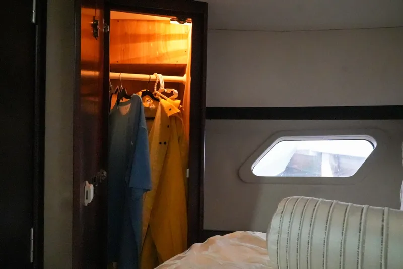 Slide: The Image of Interior of 2014 Silverton 36 Convertible yacht with open closet and window view. - 14
