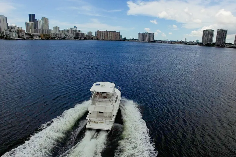 Slide: The Image of Silverton 36 Convertible yacht cruising near city skyline, 2014 model. - 37