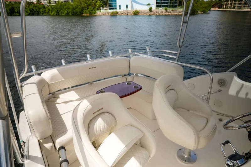 Slide: The Image of 2014 Silverton 36 Convertible yacht interior with plush seating and table on a serene water backdrop. - 22