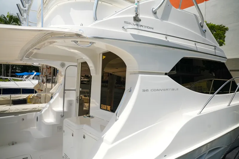 Slide: The Image of 2014 Silverton 36 Convertible yacht, sleek design, docked at marina. - 32