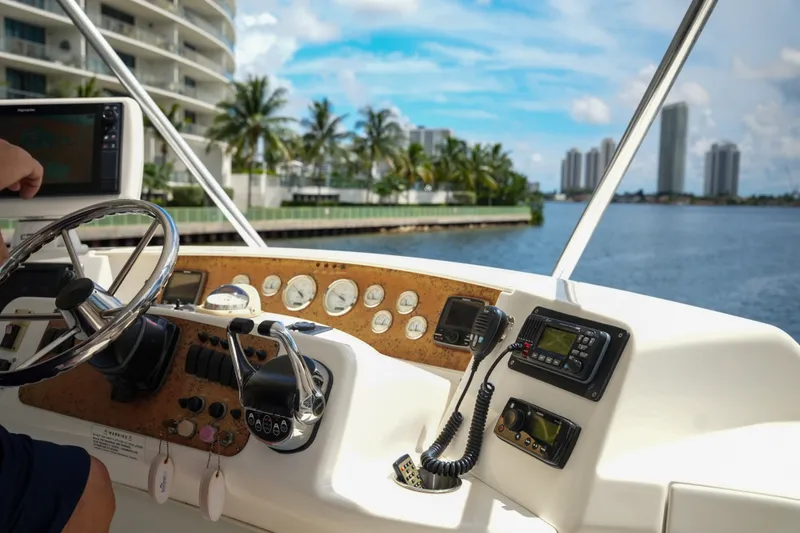 Slide: The Image of Helm of 2014 Silverton 36 Convertible yacht with cityscape and waterway view. - 19