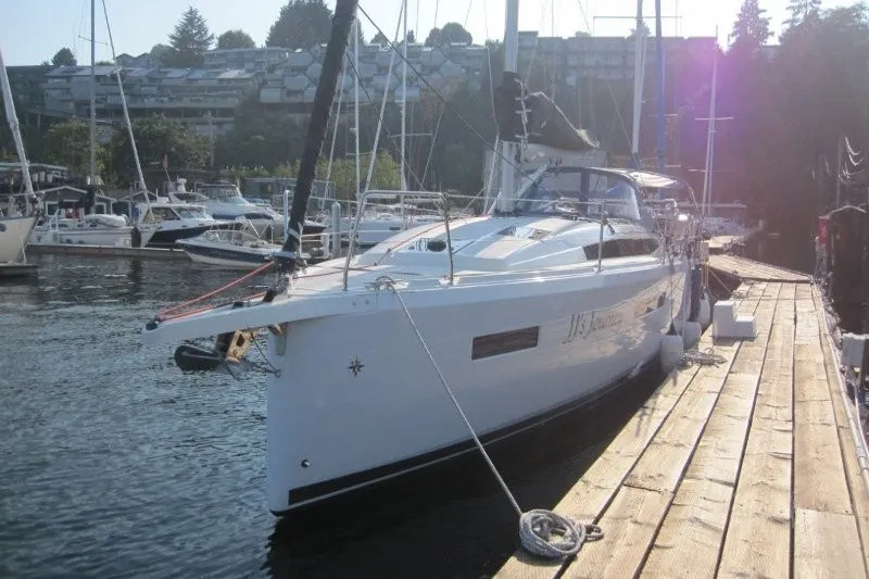 Slide: The Image of 2024 Jeanneau Sun Odyssey 380 yacht docked at a marina, surrounded by other boats. - 30
