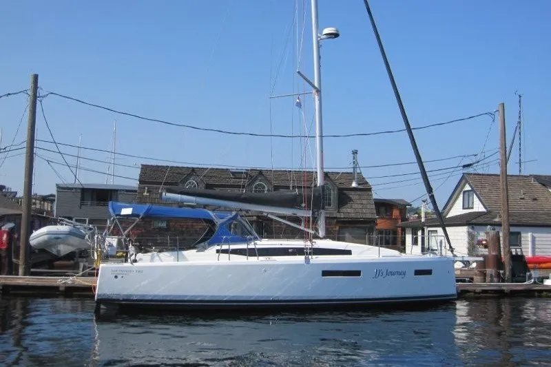 The Image of 2024 Jeanneau Sun Odyssey 380 sailboat docked at a marina, clear blue sky. - 0