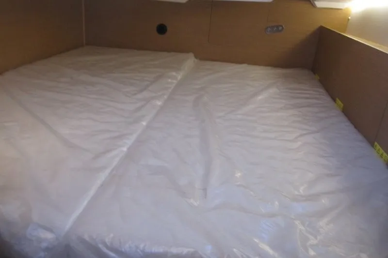 Slide: The Image of Interior cabin of 2024 Jeanneau Sun Odyssey 380 yacht with a covered mattress. - 18