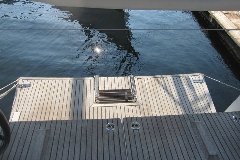 Slide: The Image of 2024 Jeanneau Sun Odyssey 380 yacht stern with teak swim platform and ladder. - 40