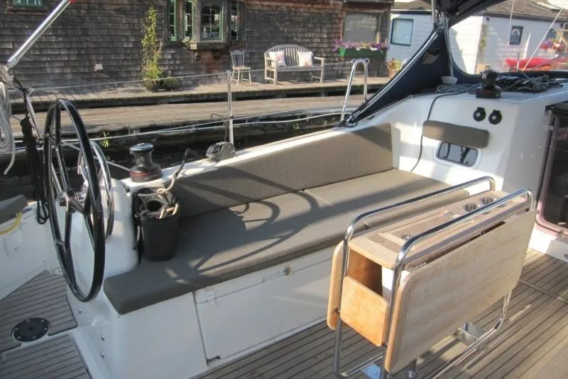 Slide: The Image of 2024 Jeanneau Sun Odyssey 380 cockpit with seating and steering wheel. - 37
