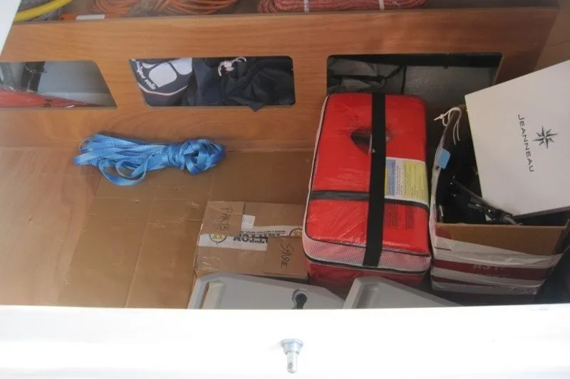 Slide: The Image of Storage compartment of 2024 Jeanneau Sun Odyssey 380 with safety gear and equipment. - 48