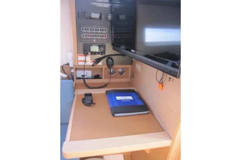 Slide: The Image of Navigation station of 2024 Jeanneau Sun Odyssey 380 with control panel and equipment. - 24