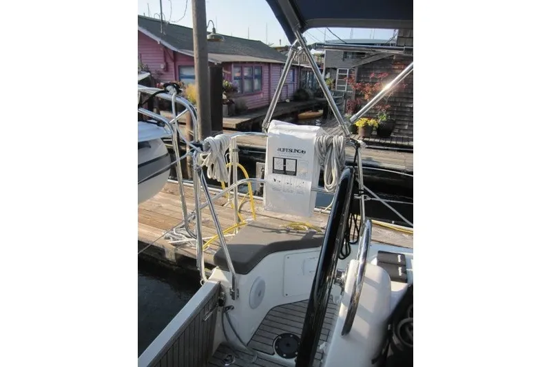 Slide: The Image of 2024 Jeanneau Sun Odyssey 380 cockpit with safety equipment and dock view. - 39
