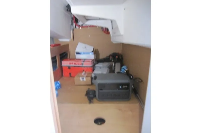 Slide: The Image of Storage area inside 2024 Jeanneau Sun Odyssey 380, featuring life jackets and equipment. - 14