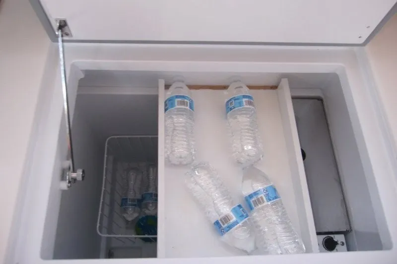 Slide: The Image of Open cooler with water bottles inside Jeanneau Sun Odyssey 380, 2024 model. - 23