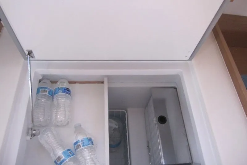 Slide: The Image of Storage compartment with water bottles in 2024 Jeanneau Sun Odyssey 380 yacht. - 22