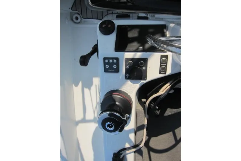 Slide: The Image of Cockpit controls of 2024 Jeanneau Sun Odyssey 380 sailboat, featuring steering wheel and navigation instruments. - 44