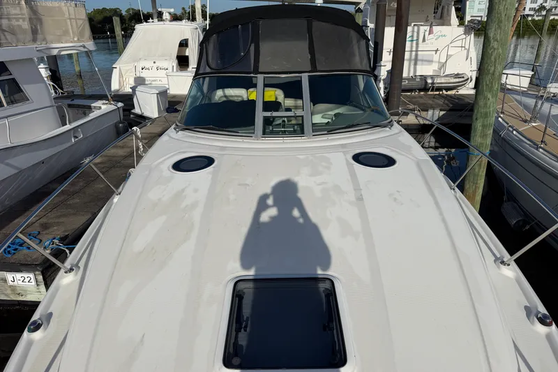 Slide: The Image of 2006 Sea Ray Sundancer 320 docked, showcasing sleek design and spacious deck. - 22