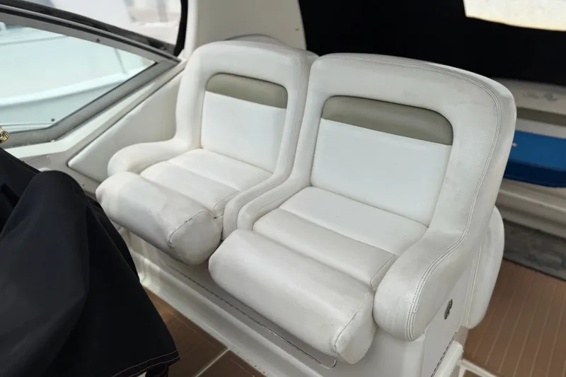 Slide: The Image of White leather seats on a 2006 Sea Ray Sundancer 320 boat interior. - 8