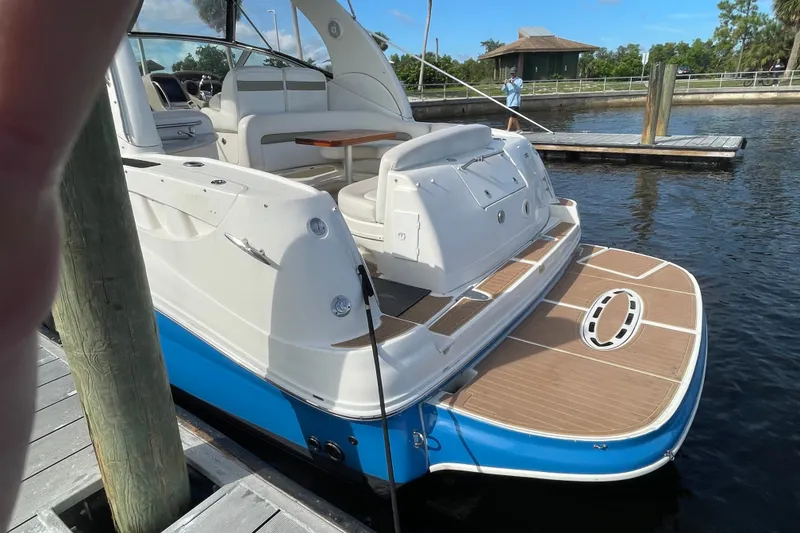 Slide: The Image of 2006 Sea Ray Sundancer 320 docked, showcasing spacious deck and elegant design. - 3