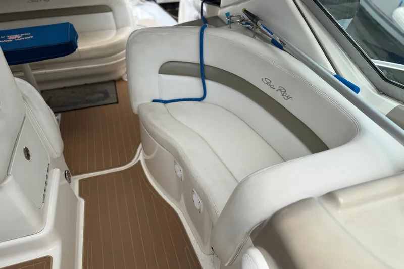 Slide: The Image of Interior seating of a 2006 Sea Ray Sundancer 320 boat, featuring white upholstery. - 9