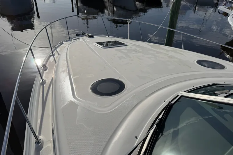 Slide: The Image of 2006 Sea Ray Sundancer 320 yacht deck with sleek design and circular windows. - 25