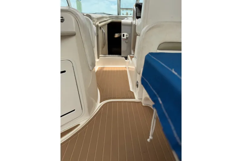 Slide: The Image of 2006 Sea Ray Sundancer 320 interior with tan flooring and blue seating. - 12