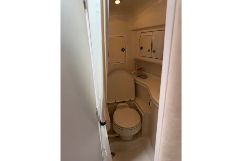 Slide: The Image of Compact bathroom in 2006 Sea Ray Sundancer 320 yacht, featuring toilet and storage cabinets. - 17