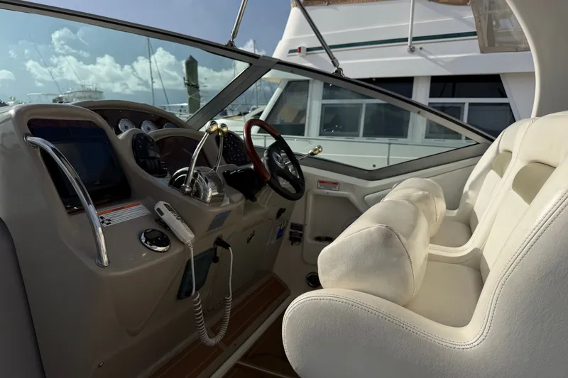 Slide: The Image of Cockpit of 2006 Sea Ray Sundancer 320 with steering wheel and controls. - 41