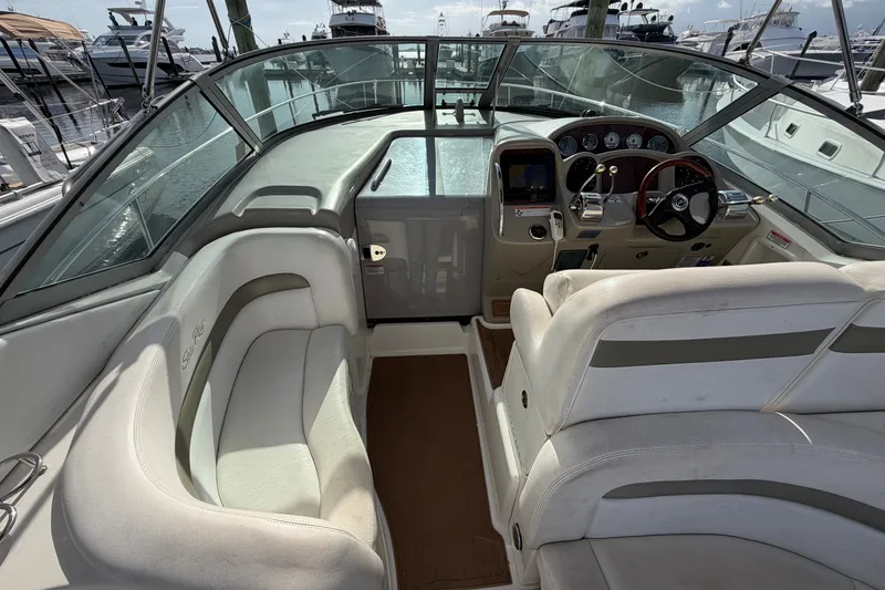 Slide: The Image of 2006 Sea Ray Sundancer 320 cockpit with white seating and modern dashboard controls. - 39