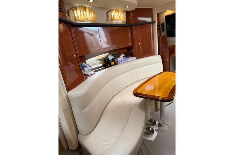 Slide: The Image of Luxurious interior of 2006 Sea Ray Sundancer 320 with elegant seating and wooden table. - 14