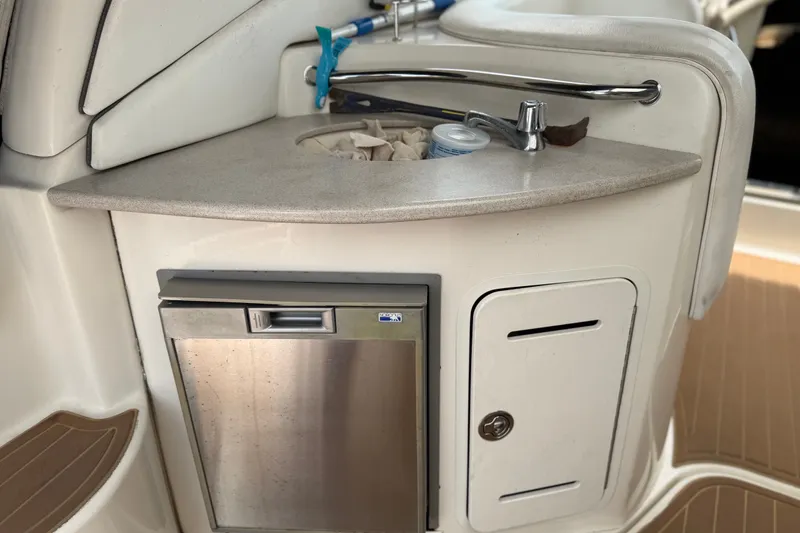 Slide: The Image of 2006 Sea Ray Sundancer 320 boat kitchenette with sink and mini fridge. - 11