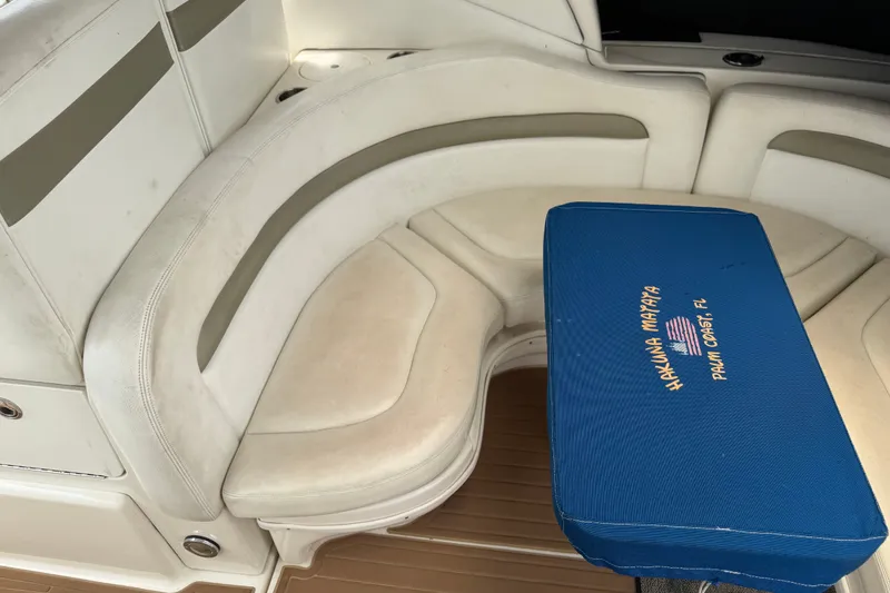 Slide: The Image of 2006 Sea Ray Sundancer 320 interior with curved seating and blue table cover. - 13