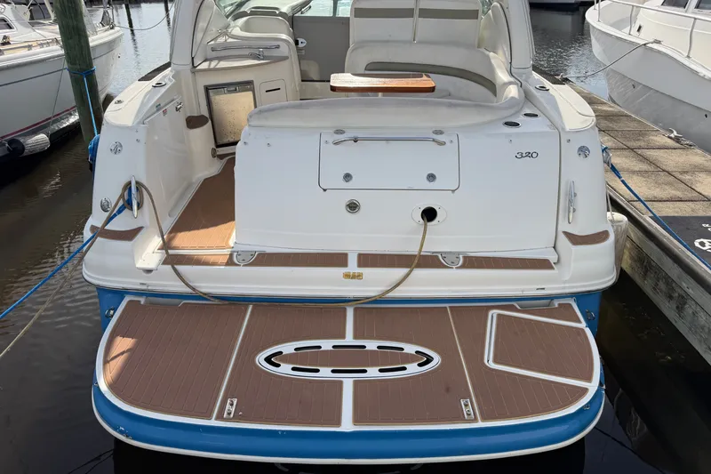 Slide: The Image of 2006 Sea Ray Sundancer 320 yacht docked, featuring spacious swim platform and seating area. - 29