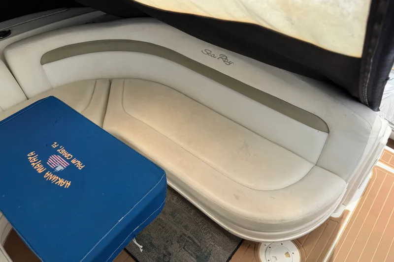Slide: The Image of Interior seating of 2006 Sea Ray Sundancer 320 with blue cushion, showcasing luxury design. - 5