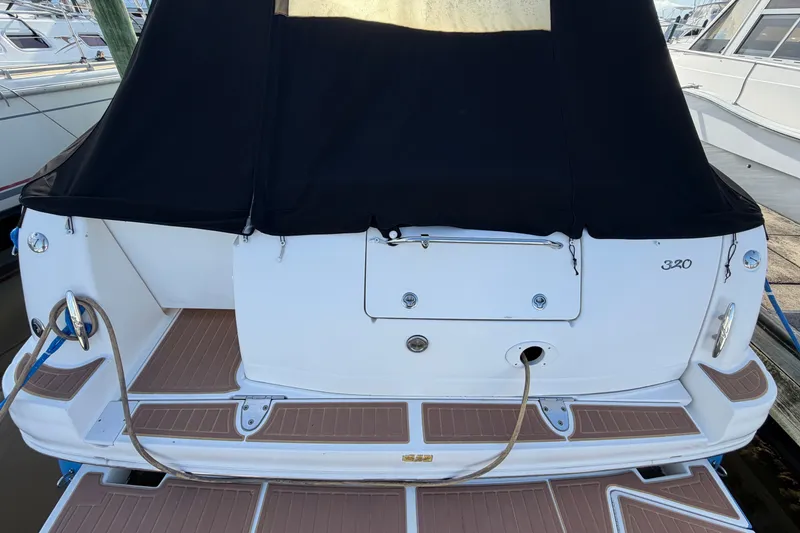 Slide: The Image of 2006 Sea Ray Sundancer 320 boat with black canopy, docked at marina. - 16